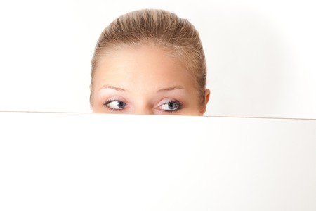 Caucasian blond woman peeping white boardの写真素材