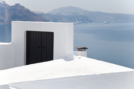 Santorini beautiful volcanic island in Greece landscape with blue churches, windmills and volcanic calderaの写真素材
