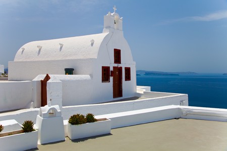 Santorini beautiful volcanic island in Greece landscape with blue churches, windmills and volcanic calderaの写真素材