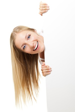 Woman peeping from whiteboardの写真素材