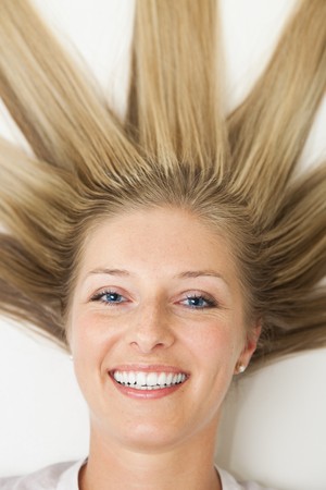 Woman with long sun rays like hair の写真素材