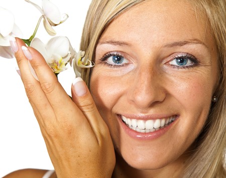 Young blond tan caucasian woman with orchid flowers isolatedの写真素材