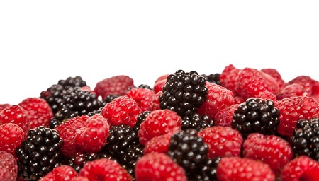 Composition of black and red raspberries on white isolated background in studio