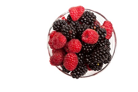 Composition of black and red raspberries on white isolated background in studioの写真素材