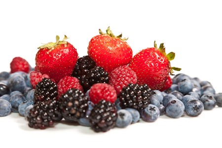 Composition of ripe black and red raspberries, strawberries and backberriesの写真素材