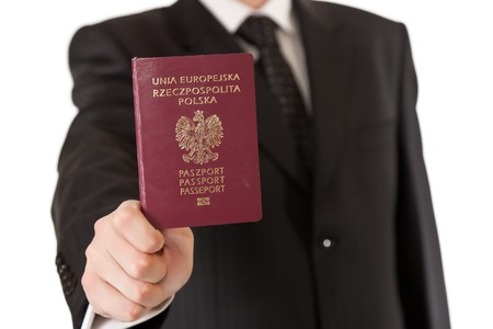 Man in suit holding passportの写真素材