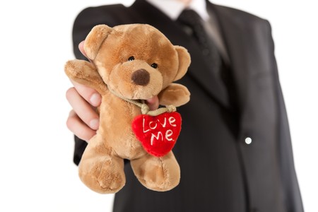 Man in suit  holding teddy bear on white isolated backgroundの写真素材