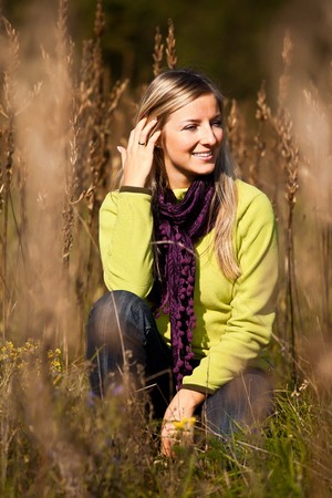 Caucasian young adult blond woman outdoor fall timeの写真素材