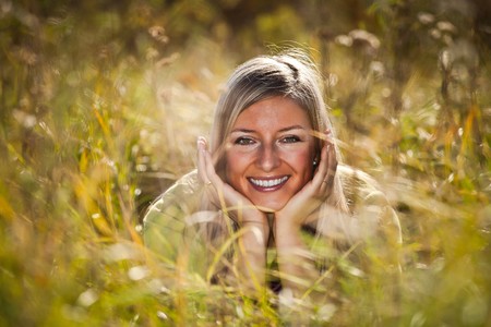 Caucasian young adult blond woman outdoor fall timeの写真素材