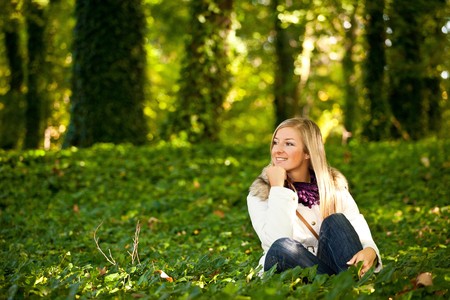 Caucasian young adult blond woman outdoor fall timeの写真素材