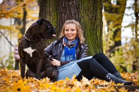 Young caucasian student girl in golden autumn parkの写真素材