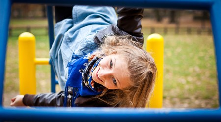 Young caucasian student girl in golden autumn park