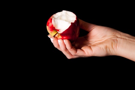 Woman holding red apple on black backgroundの写真素材