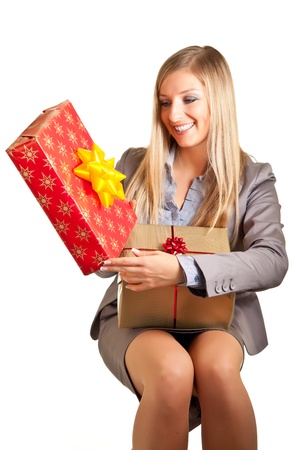 Blond caucasian woman in formal dress with gift boxes isolated on whiteの写真素材