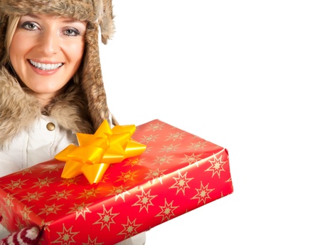 Caucasian blond woman in furry hat and christmas gifts isolated on whiteの写真素材