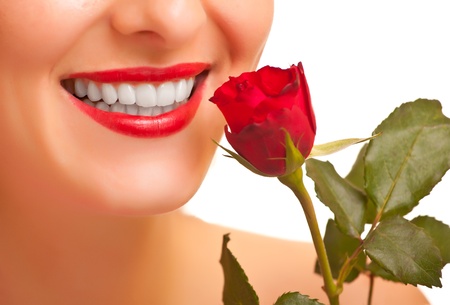 Beautiful caucasian woman with red roses on white isolated backgroundの写真素材