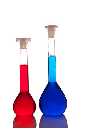 Labolatory glassware with colorful fluids isolated on whiteの写真素材