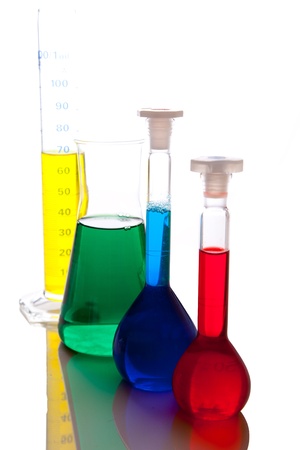 Labolatory glassware with colorful fluids isolated on whiteの写真素材