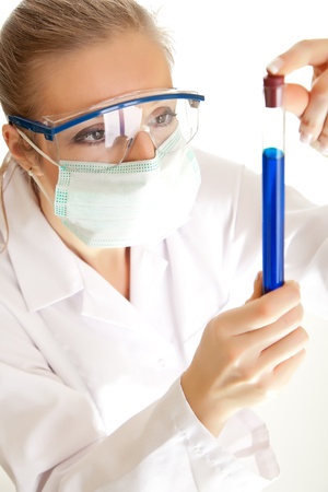 Isolated scientist woman in lab coat with chemical glassware の写真素材