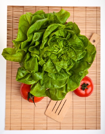 Different ripe vegetables compositions in studio laying on bamboo plateの写真素材