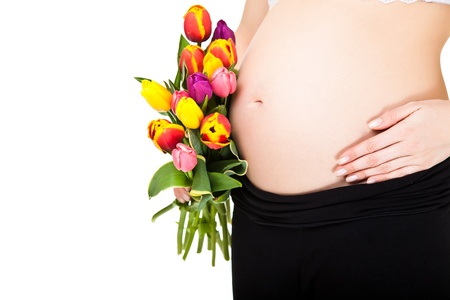 Pregnant woman belly with tulip  flowersの写真素材