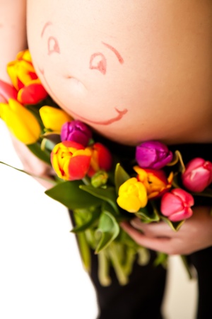 Pregnant woman belly with tulip  flowers