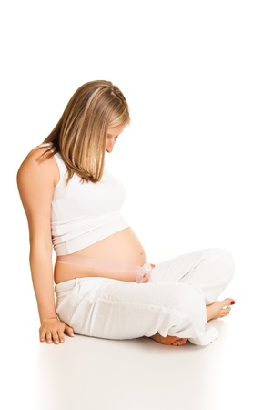 Pregnant blond woman isolated on whiteの写真素材