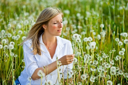 Caucasian woman in spring fieldの写真素材
