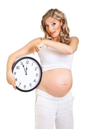 Pregnant woman with clock isolated on whiteの写真素材
