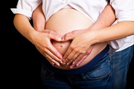 Pregnant woman on black backgroundの写真素材