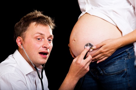Pregnant couple on black backgroundの写真素材