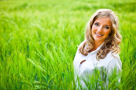 Blond woman portrait outdoor on green fieldの写真素材