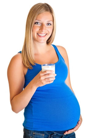Pregnant woman with glass of milk isolated on whiteの写真素材