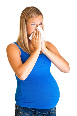 Pregnant woman wiping nose isolated on whiteの写真素材