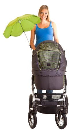 Pregnant woman with baby carriage isolated on whiteの写真素材