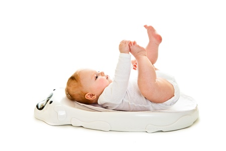 Weighting infant girl isolated on whiteの写真素材