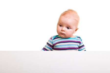 Isolated beaufiful caucasian infant baby behind whiteboardの写真素材