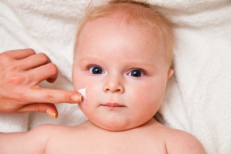 Mother creaming cute infant girl faceの写真素材