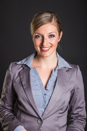 Woman in formal dress on dark gray backgroundの写真素材