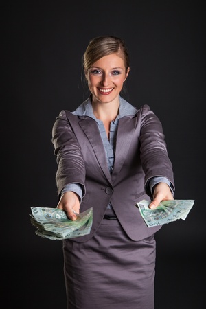 Woman with polish zloty money on dark gray backgroundの写真素材