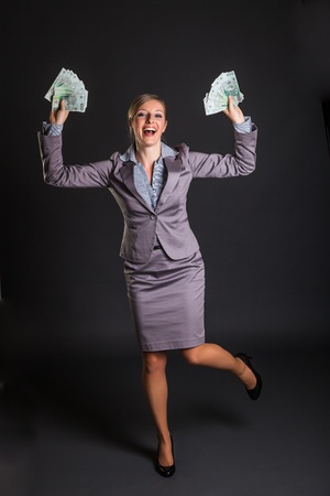 Woman with polish zloty money on dark gray backgroundの写真素材