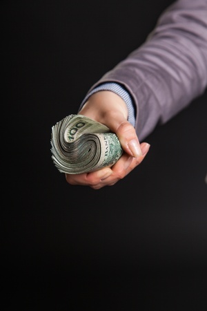 Woman with polish zloty money on dark gray backgroundの写真素材