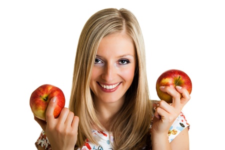Beauty blond girl with apple isolated on whiteの写真素材