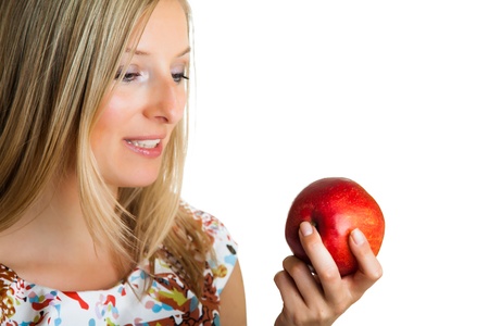 Beauty blond girl with apple isolated on whiteの写真素材