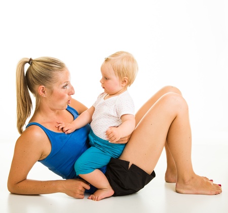 Cute infant girl with mother isolated on whiteの写真素材