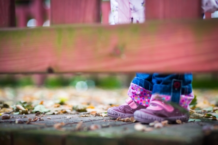 Infant baby girl in golden autumn parkの写真素材