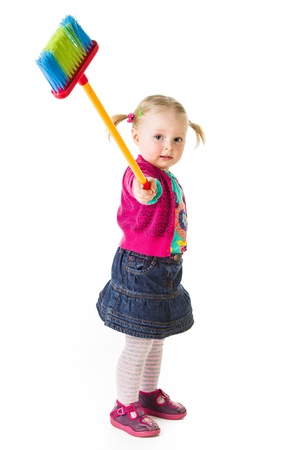 Infant girl child with a broomの写真素材