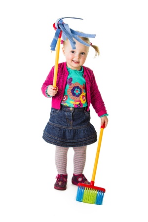 Infant girl child with a broomの写真素材
