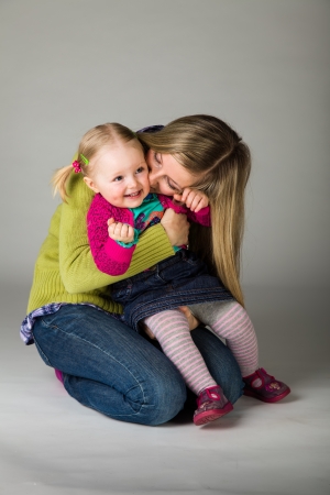 Happy infant child with her motherの写真素材