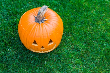 Jack-o-lantern on green grassの写真素材